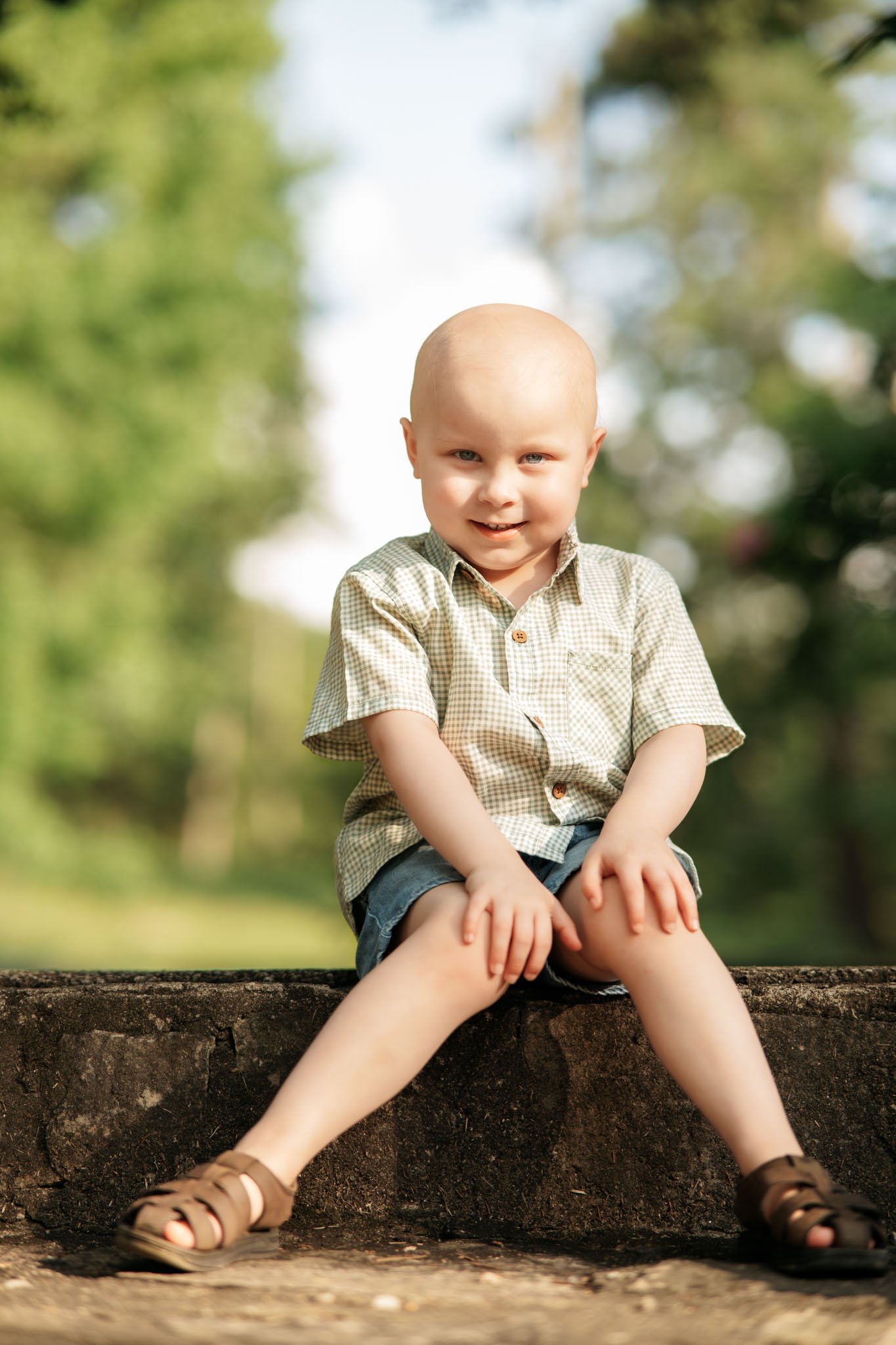 boy smiling for a photo in the park