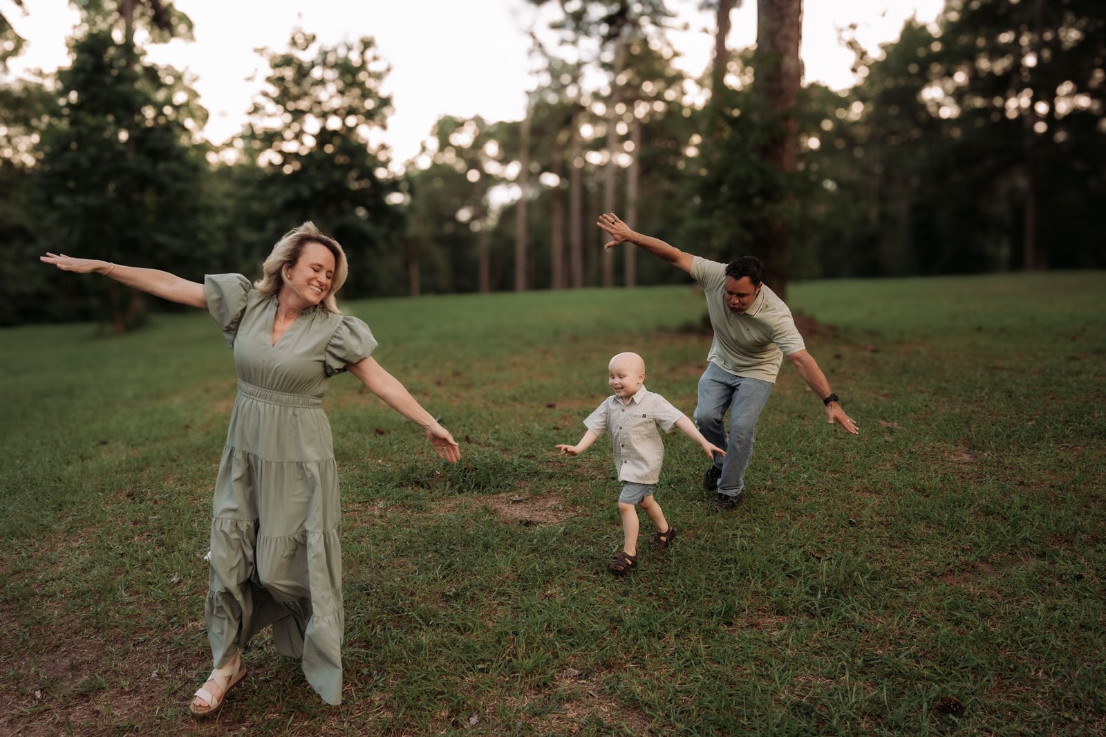 family playing airplanes in the park